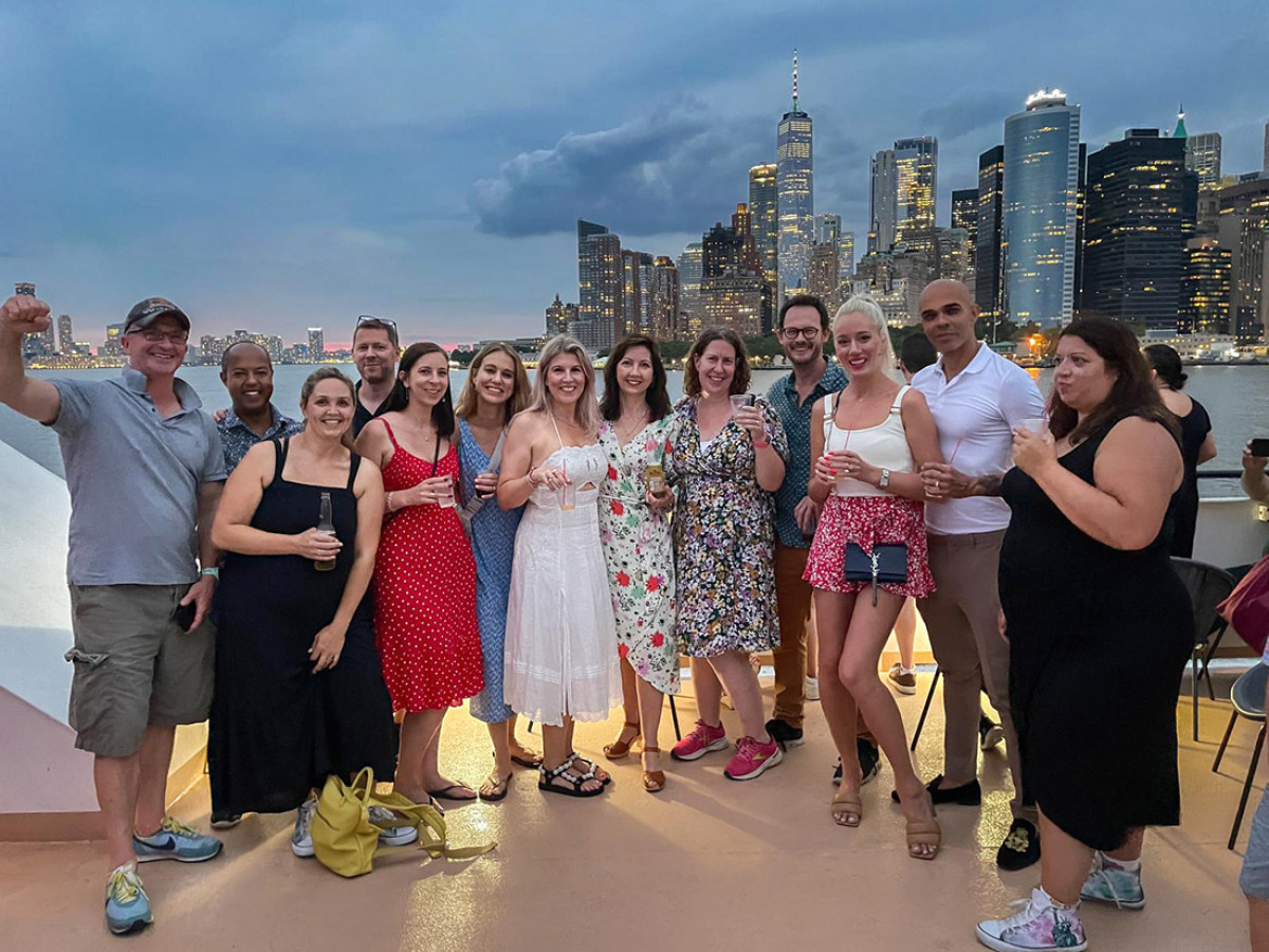 Dance student parents on a Hudson River cruise past the New York skyline at night