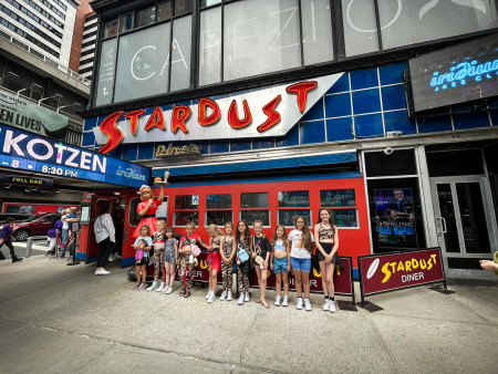 Dance group outside Ellens Stardust Diner on a performing arts trip to New York