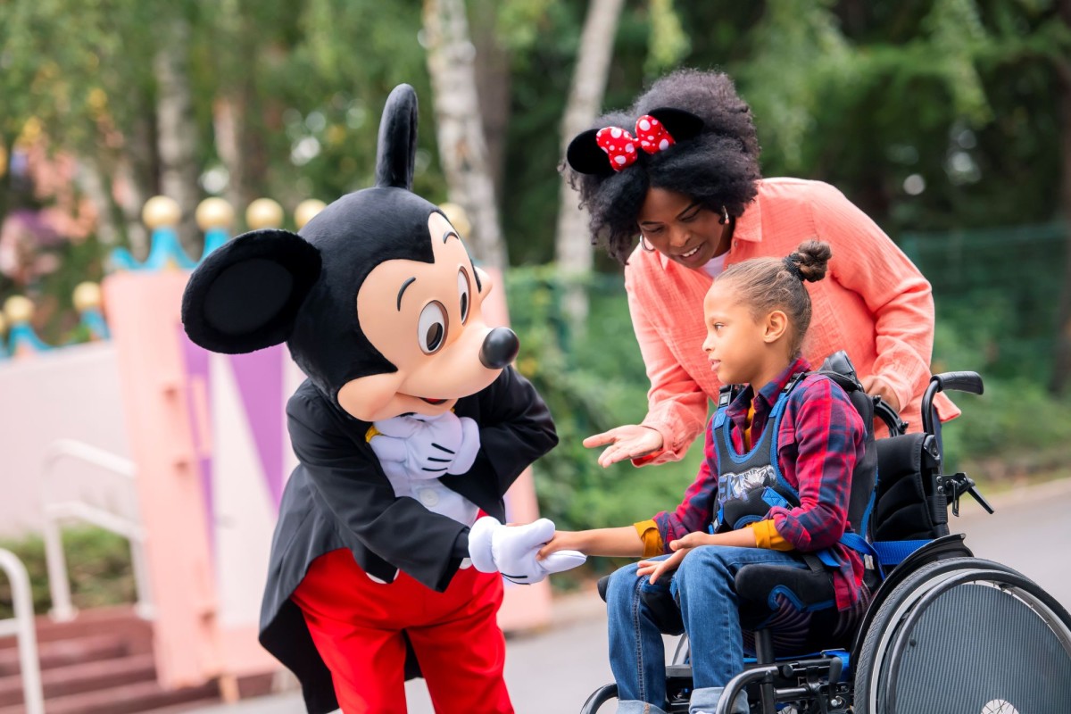 mickey greeting guest with wheelchair